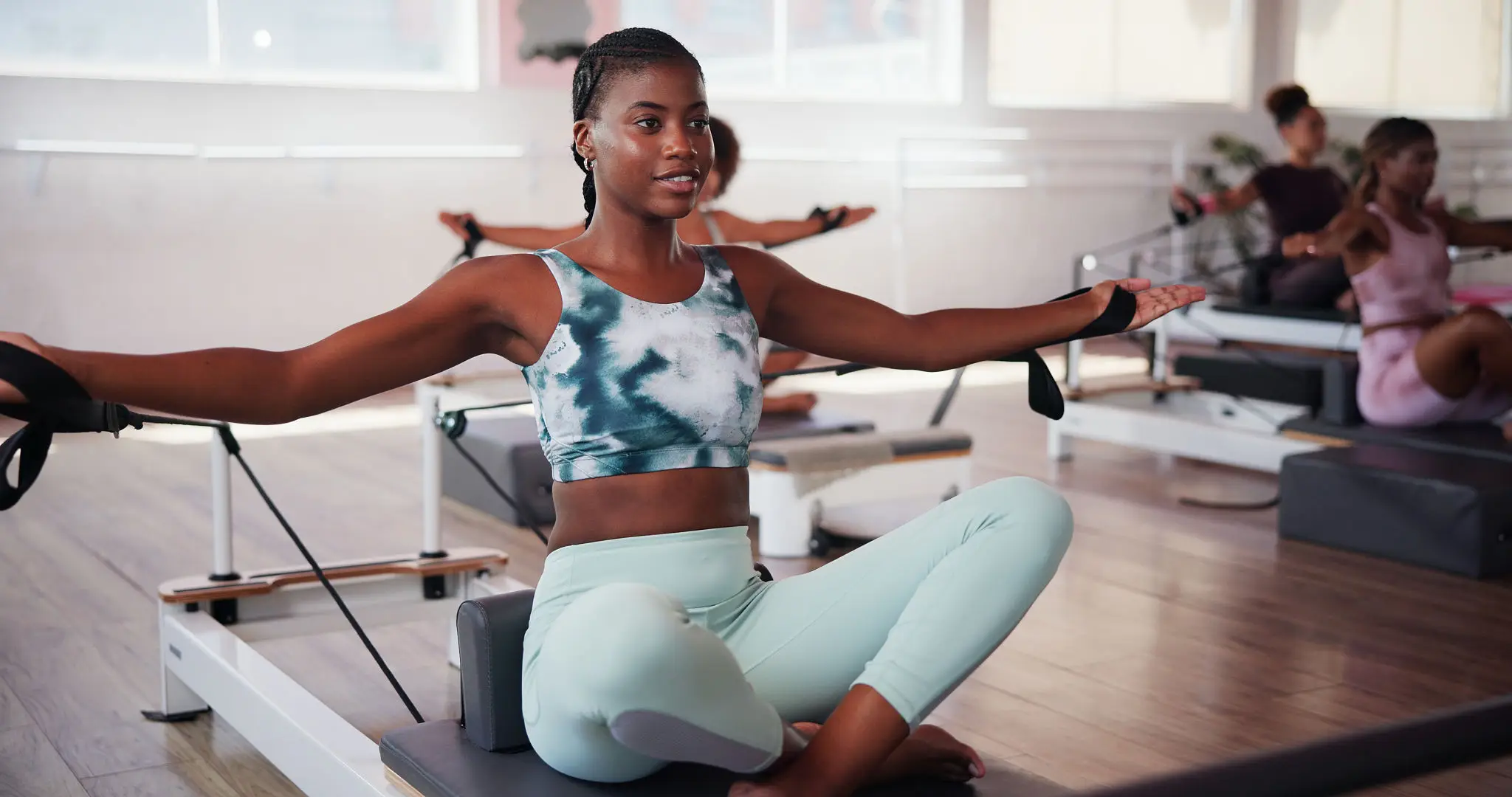 Woman practicing yoga in a bright studio.